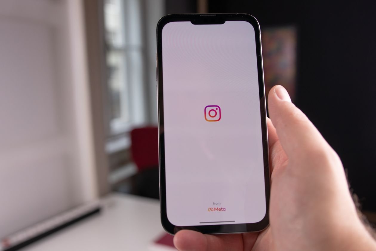 Close-up of a hand holding a smartphone with the Instagram app open