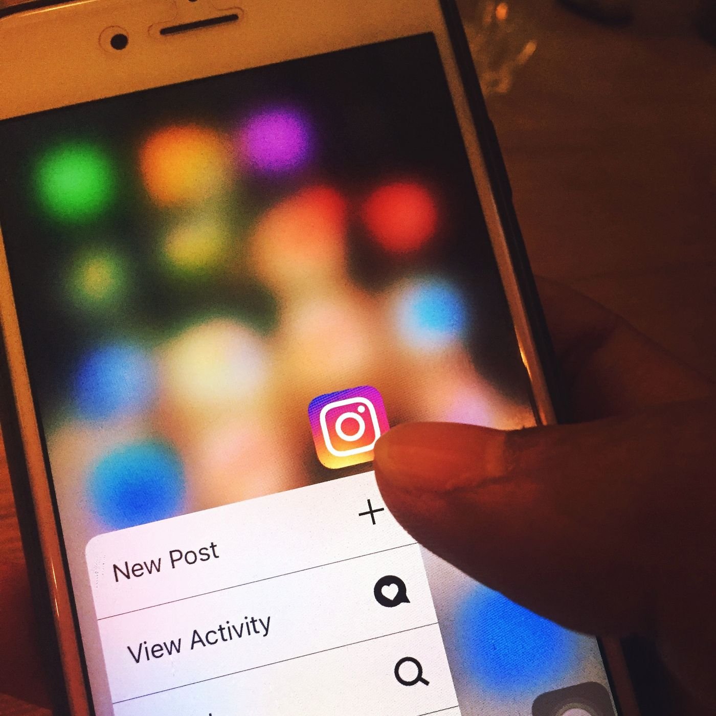 Finger scrolling the Instagram app on a smartphone screen