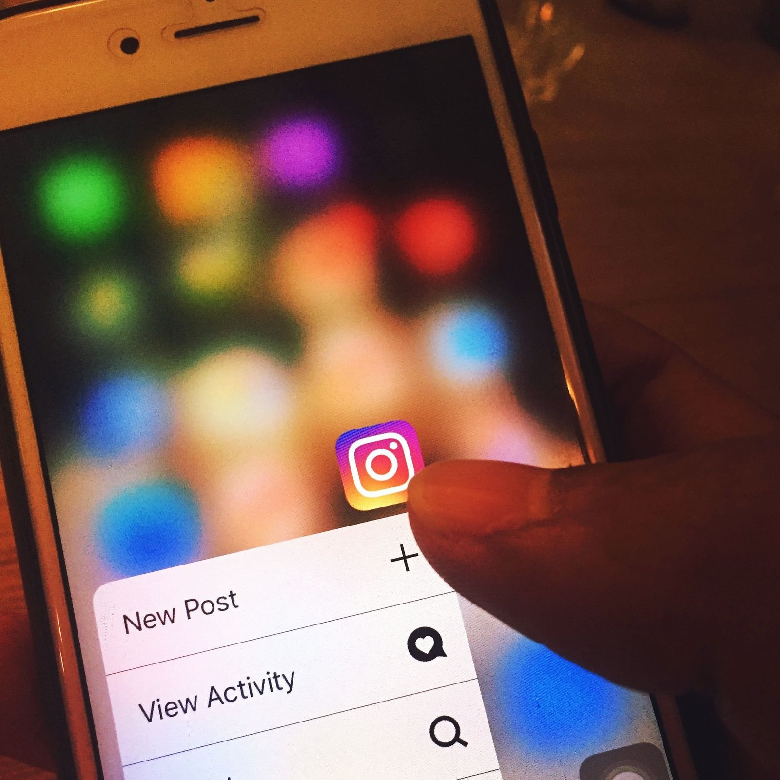 Finger scrolling through an Instagram feed on a smartphone
